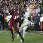 Tennessee wide receiver Cedric Tillman (4) makes a catch over South Carolina defensive back Cam Smith (9) for a 3-yard touchdown during the first half of an NCAA college football game Saturday, Nov. 19, 2022, in Columbia, S.C. (AP Photo/Artie Walker Jr.)