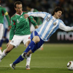 
              FILE - Argentina's Lionel Messi, right, is tackled by Mexico's Gerardo Torrado, left, during the World Cup round of 16 soccer match between Argentina and Mexico at Soccer City in Johannesburg, South Africa, Sunday, June 27, 2010. (AP Photo/Guillermo Arias, File)
            