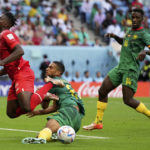 Switzerland's Breel Embolo, left, is tackled by Cameroon's Jean-Charles Castelletto during the World Cup group G soccer match between Switzerland and Cameroon, at the Al Janoub Stadium in Al Wakrah, Qatar, Thursday, Nov. 24, 2022. (AP Photo/Matthias Schrader)