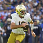 
              Notre Dame quarterback Drew Pyne (10) runs the ball during the first half of an NCAA college football game against Navy , Saturday, Nov. 12, 2022, in Baltimore. (AP Photo/Terrance Williams)
            