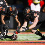 
              Oklahoma State safety Sean Michael Flanagan (18) and defensive end Kody Walterscheid (96) dive for a fumble during the first half of an NCAA college football game against Iowa State, Saturday, Nov. 12, 2022, in Stillwater, Okla. (AP Photo/Brody Schmidt)
            