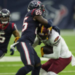 Washington Commanders wide receiver Jahan Dotson (1) is stopped on a run by Houston Texans safety Grayland Arnold (35) during the first half of an NFL football game Sunday, Nov. 20, 2022, in Houston. (AP Photo/David J. Phillip)