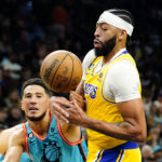 Los Angeles Lakers' Anthony Davis (3) loses the ball as Phoenix Suns' Devin Booker (1) knocks the ball away during the second half of an NBA basketball game in Phoenix, Tuesday, Nov. 22, 2022. The Phoenix Suns won the game 115-105. (AP Photo/Darryl Webb)