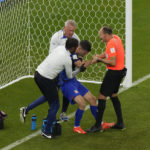 
              Christian Pulisic of the United States is helped by referee Antonio Mateu, of Spain, and team doctors after he scoring his side's opening goal during the World Cup group B soccer match between Iran and the United States at the Al Thumama Stadium in Doha, Qatar, Tuesday, Nov. 29, 2022. (AP Photo/Luca Bruno)
            