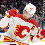 
              Calgary Flames center Elias Lindholm celebrates his goal during the first period of an NHL hockey game against the New York Islanders, Monday, Nov. 7, 2022, in Elmont, N.Y. (AP Photo/Julia Nikhinson)
            