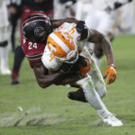South Carolina defensive back Marcellas Dial Jr. (24) tackles Tennessee wide receiver Cedric Tillman (4) after a catch during the second half of an NCAA college football game Saturday, Nov. 19, 2022, in Columbia, S.C. (AP Photo/Artie Walker Jr.)