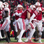 Nebraska's Trey Palmer, right, celebrates a touchdown with teammates, from left, Anthony Grant, Travis Vokolek, Oliver Martin and Turner Corcoran during the first half of an NCAA college football game against Wisconsin on Saturday, Nov. 19, 2022, in Lincoln, Neb. (AP Photo/Rebecca S. Gratz)