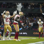 San Francisco 49ers wide receiver Brandon Aiyuk, center, celebrates his touchdown during the first half of an NFL football game against the Arizona Cardinals, Monday, Nov. 21, 2022, in Mexico City. (AP Photo/Marcio Jose Sanchez)