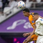 Qatar's Pedro Miguel, right, jumps for a header with Cody Gakpo of the Netherlands during the World Cup group A soccer match between the Netherlands and Qatar, at the Al Bayt Stadium in Al Khor , Qatar, Tuesday, Nov. 29, 2022. (AP Photo/Darko Bandic)