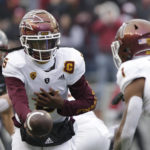 Arizona State quarterback Emory Jones, left, prepares to hand the ball to running back Xazavian Valladay during the second half of an NCAA college football game against Washington State, Saturday, Nov. 12, 2022, in Pullman, Wash. Washington State won 28-18. (AP Photo/Young Kwak)