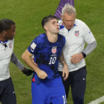 
              Christian Pulisic of the United States is helped by team doctors after he scoring his side's opening goal during the World Cup group B soccer match between Iran and the United States at the Al Thumama Stadium in Doha, Qatar, Tuesday, Nov. 29, 2022. (AP Photo/Luca Bruno)
            