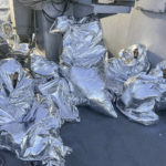 
              In this photo provided by the Greek Coast Guard, some of the nine men who survived a shipwreck and were found on an uninhabited islet are covered with a thermal blankets as they sit aboard a Greek Coast guard vessel, in the Aegean Sea, Greece, on Tuesday, Nov. 1, 2022.  (Greek Coast Guard via AP)
            