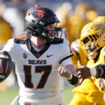 Oregon State quarterback Ben Gulbranson (17) looks to throw a pass as he gets away from Arizona State defensive lineman Nesta Jade Silveraright, during the second half of an NCAA college football game in Tempe, Ariz., Saturday, Nov. 19, 2022. Oregon State won 31-7. (AP Photo/Ross D. Franklin)