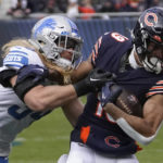 Chicago Bears wide receiver Equanimeous St. Brown (19) tries to break the tackle of Detroit Lions linebacker Alex Anzalone (34) during the first half of an NFL football game in Chicago, Sunday, Nov. 13, 2022. (AP Photo/Charles Rex Arbogast)