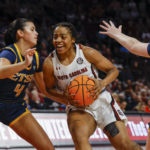 South Carolina guard Kierra Fletcher, center, drives into East Tennessee State guard Meleah Kirtner (4) during the first quarter of an NCAA college basketball game in Columbia, S.C., Monday, Nov. 7, 2022. (AP Photo/Nell Redmond)