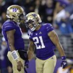
              Washington running back Wayne Taulapapa (21) celebrates his touchdown against Oregon State with quarterback Michael Penix Jr. (9) during the first half of an NCAA college football game Friday, Nov. 4, 2022, in Seattle. (AP Photo/John Froschauer)
            