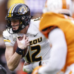 
              Missouri quarterback Brady Cook (12) runs for yardage during the first half of an NCAA college football game against Tennessee Saturday, Nov. 12, 2022, in Knoxville, Tenn. (AP Photo/Wade Payne)
            