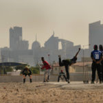 
              People play cricket in the streets in Doha, Qatar, Friday, Nov. 25, 2022. As dawn broke Friday as Qatar hosts the World Cup, the laborers who built this energy-rich country's stadiums, roads and rail filled empty stretches of asphalt and sandlots to play cricket. (AP Photo/Abbie Parr)
            
