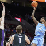 
              North Carolina guard Caleb Love, right, shoots over Portland forward Kristian Sjolund, left, and forward Moses Wood during the first half of an NCAA college basketball game in the Phil Knight Invitational tournament in Portland, Ore., Thursday, Nov. 24, 2022. (AP Photo/Craig Mitchelldyer)
            