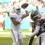 Miami Dolphins quarterback Tua Tagovailoa (1) aims a pass during the first half of an NFL football game against the Houston Texans, Sunday, Nov. 27, 2022, in Miami Gardens, Fla. (AP Photo/Michael Laughlin)