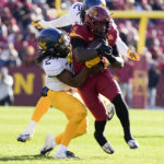 
              Iowa State running back Cartevious Norton (5) is tackled by West Virginia defensive back Aubrey Burks (2) after catching a pass during the first half of an NCAA college football game, Saturday, Nov. 5, 2022, in Ames, Iowa. (AP Photo/Charlie Neibergall)
            