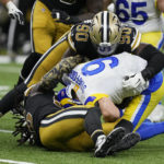 
              Los Angeles Rams quarterback Matthew Stafford (9) is sacked by New Orleans Saints defensive end Tanoh Kpassagnon (90) in the second half of an NFL football game in New Orleans, Sunday, Nov. 20, 2022. (AP Photo/Gerald Herbert)
            