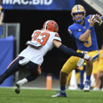 
              Pittsburgh quarterback Kedon Slovis (9) eludes Syracuse defensive back Justin Barron (23) during the first half of an NCAA college football game, Saturday, Nov. 5, 2022, in Pittsburgh. (AP Photo/Barry Reeger)
            