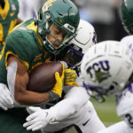 
              Baylor wide receiver Monaray Baldwin (80) is wrapped up by TCU linebacker Shadrach Banks (19) during the first half of an NCAA college football game in Waco, Texas, Saturday, Nov. 19, 2022. (AP Photo/LM Otero)
            