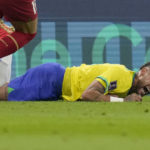 
              Brazil's Neymar grimaces as he falls to the ground during the World Cup group G soccer match between Brazil and Serbia, at the Lusail Stadium in Lusail, Qatar, Thursday, Nov. 24, 2022. (AP Photo/Andre Penner)
            