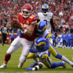 
              Kansas City Chiefs tight end Travis Kelce (87) scores on a 39-yard touchdown reception ahead of Los Angeles Rams safety Nick Scott, lower right, and cornerback Jalen Ramsey during the first half of an NFL football game Sunday, Nov. 27, 2022, in Kansas City, Mo. (AP Photo/Ed Zurga)
            