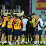 
              Spain head coach Luis Enrique, second from right, joins his team in a huddle before working out during a training session at Qatar University, in Doha, Qatar, Tuesday, Nov. 22, 2022. Spain will play its first match in Group E in the World Cup against Costa Rica on Nov. 23. (AP Photo/Julio Cortez)
            