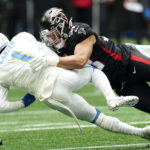 Los Angeles Chargers' DeAndre Carter (1) is tackled by Atlanta Falcons' Nick Kwiatkoski, right, while returning a punt during the first half of an NFL football game, Sunday, Nov. 6, 2022, in Atlanta. (AP Photo/John Bazemore)