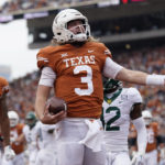 
              Texas quarterback Quinn Ewers (3) celebrates after scoring a touchdown against Baylor during the first half of an NCAA college football game in Austin, Texas, Friday, Nov. 25, 2022. (AP Photo/Eric Gay)
            