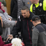 
              Iowa State head coach Matt Campbell arrives for an NCAA college football game against West Virgina, Saturday, Nov. 5, 2022, in Ames, Iowa. College athletic programs of all sizes are reacting to inflation the same way as everyone else. They're looking for ways to save. Travel and food are the primary areas with increased costs. (AP Photo/Charlie Neibergall)
            