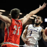 
              Kansas State guard Markquis Nowell (1) shoots under pressure from Texas-Rio Grande Valley forward Alex Horiuk (21) during the second half of an NCAA college basketball game Monday, Nov. 7, 2022, in Manhattan, Kan. (AP Photo/Charlie Riedel)
            