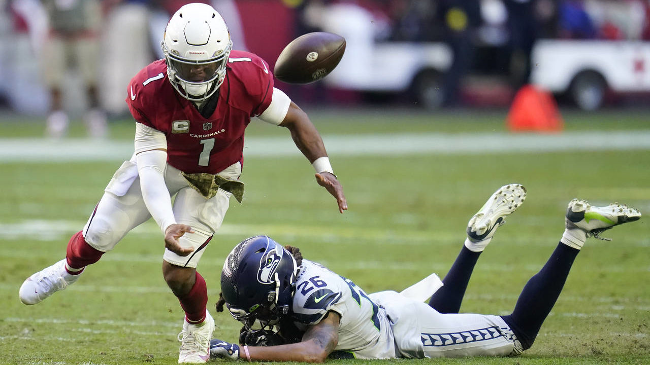 Arizona Cardinals quarterback Kyler Murray (1) fumbles the ball after being hit by Seattle Seahawks...