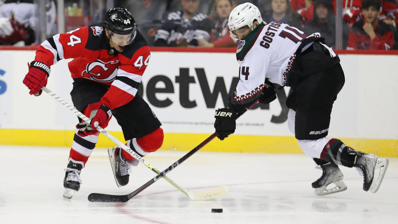New Jersey Devils left wing Miles Wood (44) plays the puck against Arizona Coyotes defenseman Shayn...
