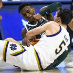 
              Michigan State's Tyson Walker, rear, and Notre Dame's Cormac Ryan, right, fight for a rebound during the first half of an NCAA college basketball game Wednesday, Nov. 30, 2022, in South Bend, Ind. (AP Photo/Michael Caterina)
            