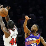 
              Phoenix Suns forward Mikal Bridges, right, blocks a shot by Chicago Bulls forward Patrick Williams (44) during the first half of an NBA basketball game in Phoenix, Wednesday, Nov. 30, 2022. (AP Photo/Ross D. Franklin)
            