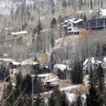 
              Houses dot a hillside in the ski resort town of Vail, Colo., on Oct. 25, 2022. A dearth of affordable housing threatens dozens of businesses that serve up food, fun and fashion for the thousands of visitors who converge on the area during ski season. (AP Photo/Thomas Peipert)
            