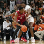 
              Miami's guard Wooga Poplar (55) defends Rutgers' forward Aundre Hyatt (5) during the first half of an NCAA college basketball game, Wednesday, Nov. 30, 2022, in Coral Gables, Fla. (AP Photo/Marta Lavandier)
            