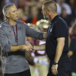 
              Florida State head coach Mike Norvell, left, shakes hands with Florida head coach Billy Napier, right, before an NCAA college football game Friday, Nov. 25, 2022, in Tallahassee, Fla. (AP Photo/Phil Sears)
            