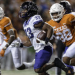TCU running back Kendre Miller (33) runs past Texas defensive end Barryn Sorrell (88) during the second half of an NCAA college football game Saturday, Nov. 12, 2022, in Austin, Texas. (AP Photo/Stephen Spillman)