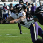 Baltimore Ravens tight end Josh Oliver (84) can't complete a pass against Jacksonville Jaguars safety Rayshawn Jenkins (2) during the second half of an NFL football game, Sunday, Nov. 27, 2022, in Jacksonville, Fla. (AP Photo/John Raoux)