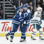 
              Toronto Maple Leafs' Mitchell Marner, left, celebrates with Auston Matthews after scoring an empty-net goal against the San Jose Sharks during the third period of an NHL hockey game Wednesday, Nov. 30, 2022, in Toronto. (Chris Young/The Canadian Press via AP)
            