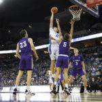 Creighton's Ryan Kalkbrenner (11) shoots against St. Thomas' Will Engels (23), Parker Bjorklund (5) and Andrew Rohde (3) during the first half of an NCAA college basketball game Monday, Nov. 7, 2022, in Omaha, Neb. (AP Photo/Rebecca S. Gratz)