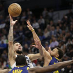 
              Minnesota Timberwolves guard Austin Rivers shoots over Golden State Warriors guard Stephen Curry, right, during the second quarter of an NBA basketball game Sunday, Nov. 27, 2022, in Minneapolis. (AP Photo/Andy Clayton-King)
            