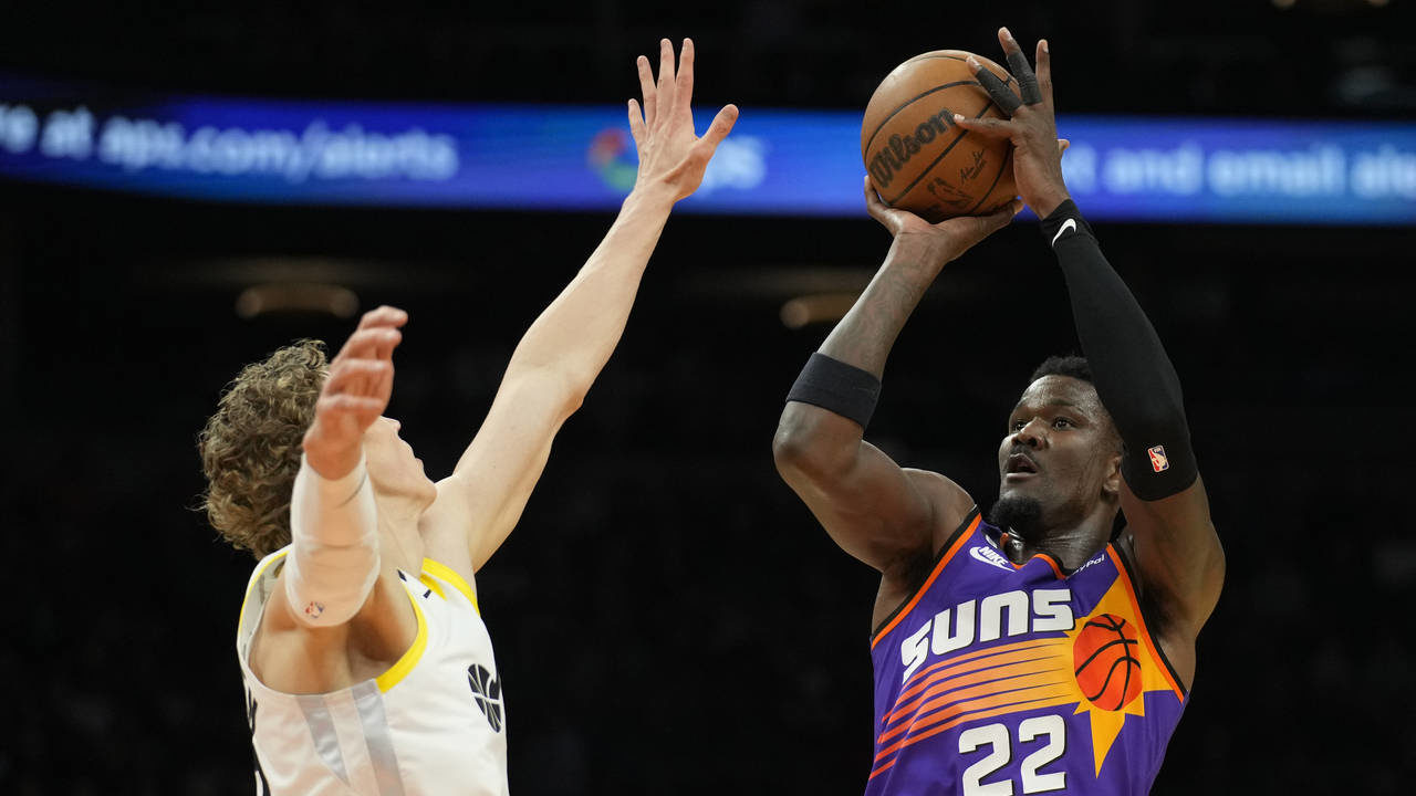 Phoenix Suns center Deandre Ayton (22) shoots over Utah Jazz forward Lauri Markkanen during the sec...