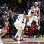 
              Portland Trail Blazers players mob guard Josh Hart (11) after he made a 3-point shot at the buzzer to win an NBA basketball game against the Miami Heat, Monday, Nov. 7, 2022, in Miami. (AP Photo/Wilfredo Lee)
            