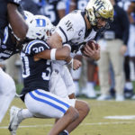 
              Wake Forest's Sam Hartmam, right, is tackled by Duke's Brandon Johnson (30) during the first half of an NCAA college football game in Durham, N.C., Saturday, Nov. 26, 2022. (AP Photo/Ben McKeown)
            
